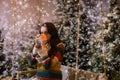 Young woman sitting on a swing and drinking hot drink from a cup Royalty Free Stock Photo