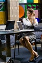 Young woman sitting at table with laptop computer Royalty Free Stock Photo