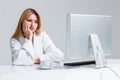 Young woman sitting in the table and using computer Royalty Free Stock Photo