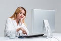 Young woman sitting in the table and using computer Royalty Free Stock Photo