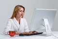 Young woman sitting in the table and using computer Royalty Free Stock Photo