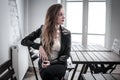 Young woman sitting at a table waiting Royalty Free Stock Photo