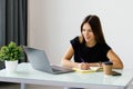 Young woman sitting at a table and writing notes. Businesswoman working at her desk Royalty Free Stock Photo