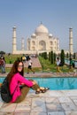 Young woman sitting at Taj Mahal complex in Agra, Uttar Pradesh, India