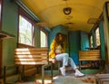 Young woman sitting on a train, sexy young girl sitting on a train, young woman sitting on a chair in train Royalty Free Stock Photo