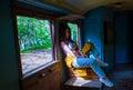 Young woman sitting on a train, sexy young girl sitting on a train, young woman sitting on a chair in train