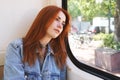 Young woman sitting in tram or streetcar looking out of the window Royalty Free Stock Photo