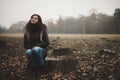 Young woman sitting tree trunk