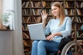 Young woman sitting in a wheelchair disability concept using laptop Royalty Free Stock Photo