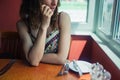 Woman in restaurant looking out window Royalty Free Stock Photo