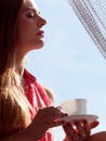 Woman looking through window, relaxing drinking coffee Royalty Free Stock Photo