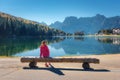 Young woman sitting on the wooden bench near the lake Royalty Free Stock Photo