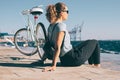 Young woman sitting on wooden embankment Royalty Free Stock Photo