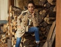 Young woman sitting in woodshed