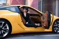 Young woman sitting in a yellow sports car Royalty Free Stock Photo