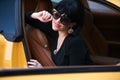 Young woman sitting in a yellow sports car Royalty Free Stock Photo