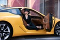 Young woman sitting in a yellow sports car Royalty Free Stock Photo