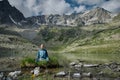 Young woman is sitting in yoga lotus position against the turquoise lake in the mountains Royalty Free Stock Photo