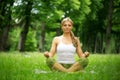 Young woman sitting in yoga position in the park Royalty Free Stock Photo