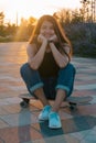 young woman with skateboard summer portrait