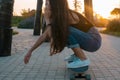 young woman with skateboard summer portrait