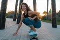 Young woman with skateboard summer portrait