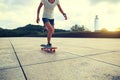 Woman skateboarder riding skateboard at city