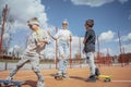 Young woman skating with her sons at playground. Happy family concept. Royalty Free Stock Photo