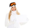 Young woman in ski glasses with empty board for the text. Royalty Free Stock Photo