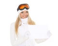 Young woman in ski glasses with empty board for the text. Royalty Free Stock Photo