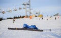 Young woman skier after the fall on mountain slope