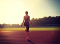 Woman skipping rope during sunny morning on stadium track Royalty Free Stock Photo