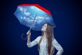 Young woman with sky design umbrella on dark blue background Royalty Free Stock Photo