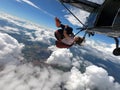 Young woman skydiver jumping from the plane