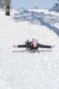 Young woman sledding in snow. laughing girl in winter clothing goes down on sleds down the hill. ertical photo Royalty Free Stock Photo