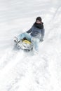 Young woman sledging in the deep snow