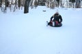 A Young Woman Sledging Down Hill Bright and Joyful Winter Scene. Royalty Free Stock Photo