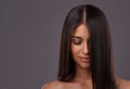 Its her crowning glory. A young woman with sleek hair posing in studio.