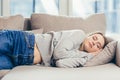 Young woman sleep resting at home on couch after a hard day`s work. Relax calm and rest. On a soft cozy comfortable sofa. Royalty Free Stock Photo