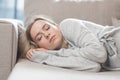 Young woman sleep resting at home on couch after a hard day`s work. Relax calm and rest. On a soft cozy comfortable sofa. Royalty Free Stock Photo