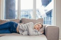 Young woman sleep resting at home on couch after a hard day`s work. Relax calm and rest. On a soft cozy comfortable sofa. Royalty Free Stock Photo