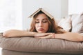 Young woman sleep on sofa with book on head Royalty Free Stock Photo