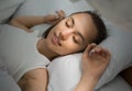 Young Woman Sleeping In Bed Comfortably And Blissfully