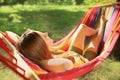 Young woman sleeping in comfortable hammock