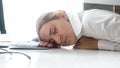 Portrait of young woman sleeping on desk at office Royalty Free Stock Photo