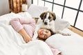 Young woman sleeping lying on bed with dog at bedroom Royalty Free Stock Photo