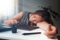 Young woman sleeping in the workplace. Fatigue and overload in office work. Morning light