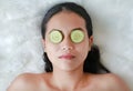 Young woman with a slice of cucumber in her eye, concept for skin care Royalty Free Stock Photo