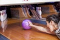 Young woman sliding down a bowling alley