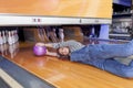 Young woman sliding down a bowling alley